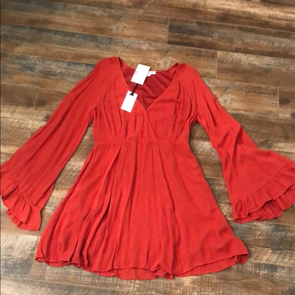 Orange tunic with ruffle detailed sleeves